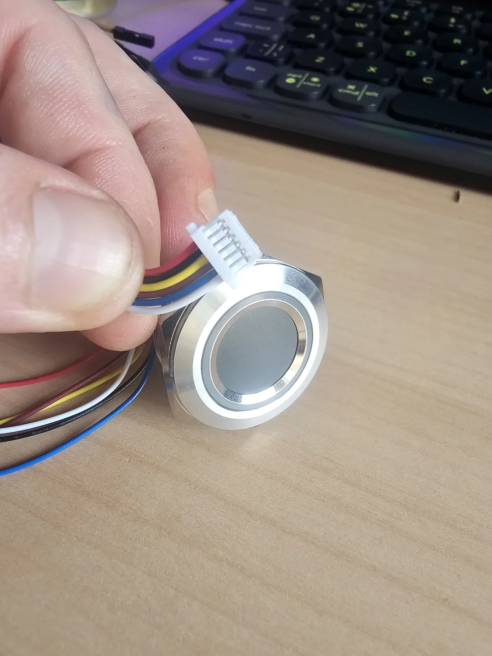 R503 fingerprint reader being inspected before installation