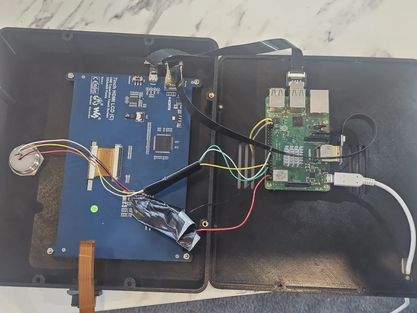 Inside the Pulse clock-in terminal showing screen board, Raspberry Pi and connections