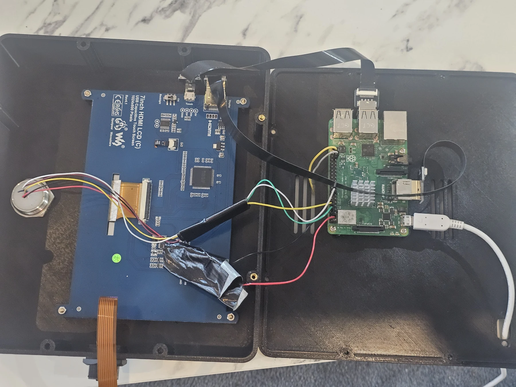 Opened terminal enclosure showing the Raspberry Pi and screen controller